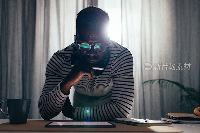 Serious BusinessmanÂ Working At Home On A Digital Tablet